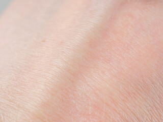 Fototapeta premium A macro shot of human skin showing the detailed structures, texture and saturation of natural hues.
