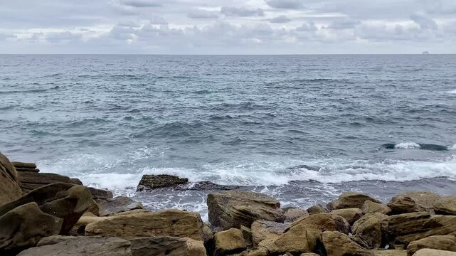 Waves crashing on rocks: Queenscliff Manly Beach, Australia 