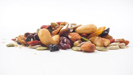 Gourmet blend of nuts seeds and dried fruits isolated on white background