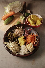 Traditional Indonesian Vegetable Salad (Asinan Sayur) with Spicy Sweet Sauce. A fresh and crunchy Indonesian vegetable salad (Asinan Sayur) served with a tangy, spicy, and sweet sauce.