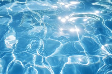Obraz premium Blue water surface with bright sun light reflections, water in swimming pool background closeup