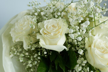White roses and gypsophila bouquet on white background.