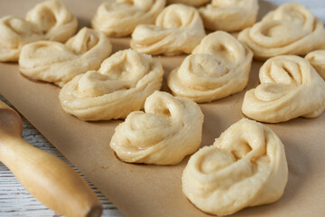 Raw buns on a baking sheet. Selective focus.