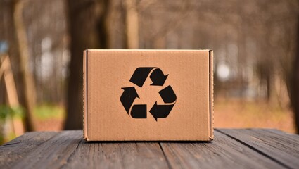 Cardboard Box with Recycling Symbol in Earthy Brown Tones for Sustainable Retail Packaging, Selective focus