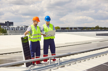 Technicians on the roof, using a laptop to install or maintain solar panels. This work ensures the efficient operation of the photovoltaic system, harnessing solar power for energy production.