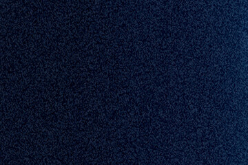 A close up shot of a dark blue textured surface with a grainy and speckled appearance throughout image