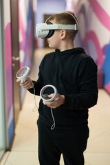 a child in virtual reality glasses plays a game
