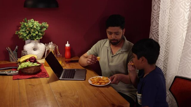 Father and son are taking and enjoying their snacks