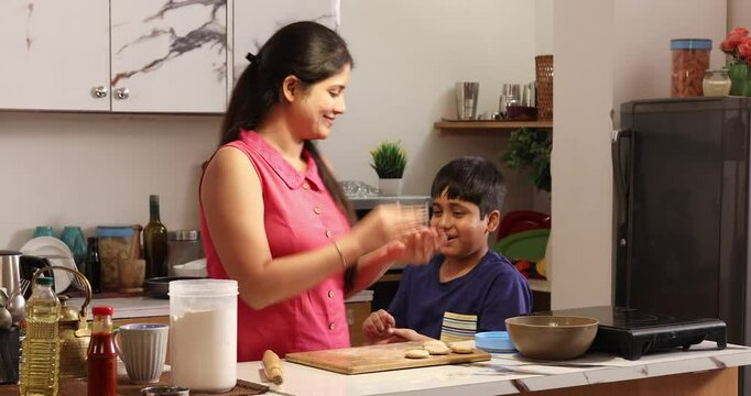 Mother and son making chapatis together