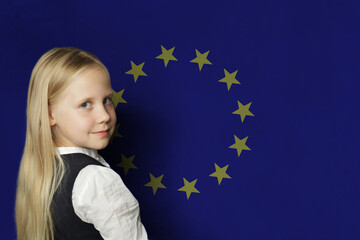 Cute young child girl on flag of EU background. Education in European Union concept