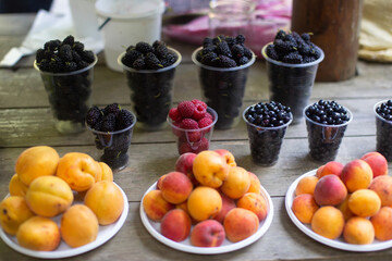 fresh fruits of peaches and raspberries on the counter in summer