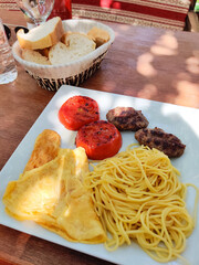 a delicious dish of pasta with cutlet on a plate in a restaurant