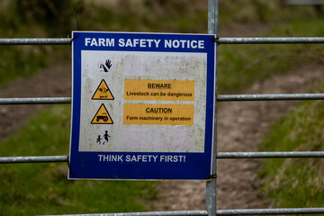 Sign on a farm gate in rural Ireland Farm safety notice 