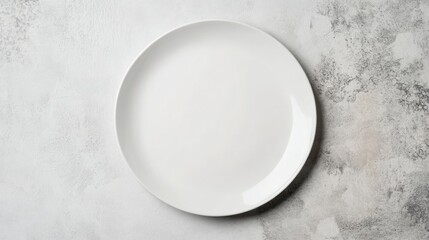 an empty white plate on a textured surface.