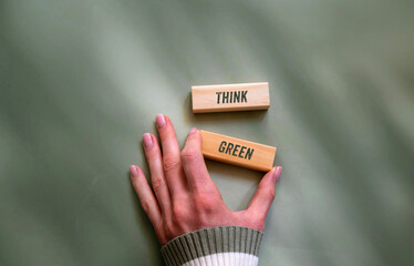 Think green text written on wooden cubes green background