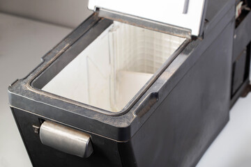 Black car refrigerator on a white background, mobile refrigerator, close-up