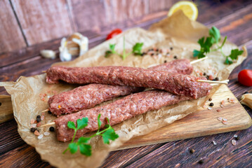 Raw Turkish adana shish kebab skewers