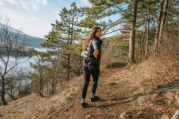 Naklejka premium Beautiful young smiling woman in the spring pine forest 