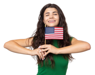 A young happy girl with a smile on her face holds an American flag in her hands. Symbol of patriotism and freedom.