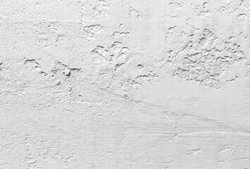 A wall with a white background and a few spots of color