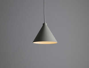 Modern pendant lamp hanging against a gray wall