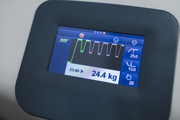 traction neck therapy, physical therapy, digital display shows traction therapy settings with weight of 24.4 kg, indicating physical therapy progress and neck treatment effectiveness