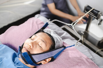 traction neck therapy, physical therapy, patient undergoing neck therapy is receiving physical...