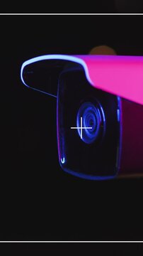 A cuttingedge, futuristic security camera featuring vibrant neon lighting for enhanced appeal