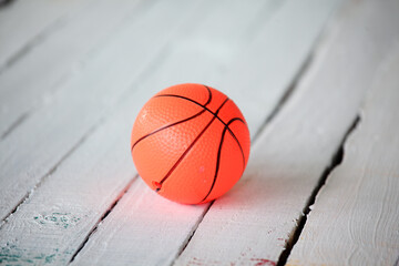 Bright Orange Basketball on Rustic Wooden Surface, Close-Up View