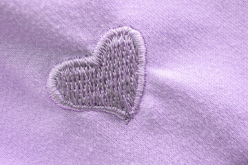 Heart symbol on fabric texture background