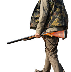 Mature man hunter with gun while walking on field.
