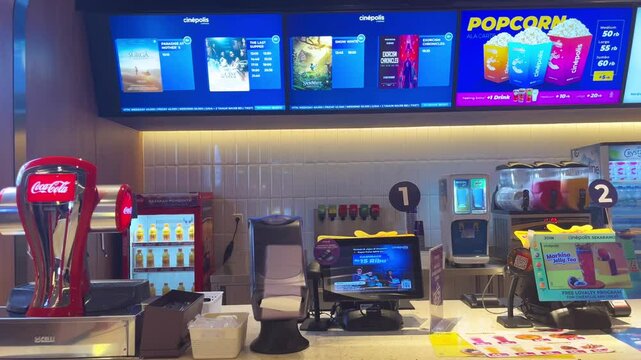 Jakarta, Indonesia - March 08, 2025:  Interior atmosphere of the Cinepolis cinema in Jakarta. Concession or snack stand where people buy popcorn and soda