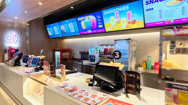 Jakarta, Indonesia - March 08, 2025:  Interior atmosphere of the Cinepolis cinema in Jakarta. Concession or snack stand where people buy popcorn and soda