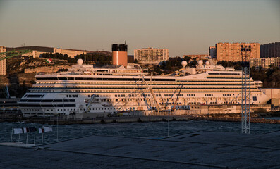 Obraz premium Modern cruise ship cruiseship liner Fortuna in dry dock maintenance modernization process at shipyard in Marseille Provence, France with dock and cranes 
