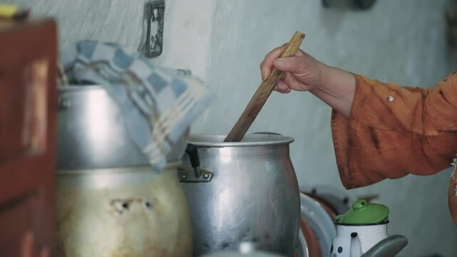 Person Cooking Traditional Meal in Rustic Kitchen Environment in Matmata Berber village in Tunisia
