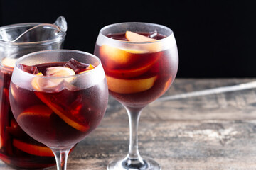 Refreshing Summer Citrus Fruit Sangria in crystal jar on wooden table. Copy space