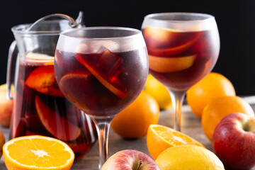 Refreshing Summer Citrus Fruit Sangria in crystal jar on wooden table