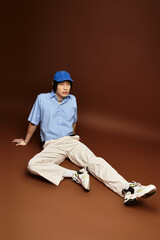 Stylish young Asian man poses in a modern studio setting with flair