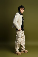 Fototapeta premium Stylish young man posing confidently in contemporary studio environment