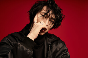 Pondering style korean model in fashion studio with red background