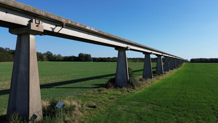 Fototapeta premium Drone picture of an experimental monorail for an experimental french aerotrain, center of France, during the 1970's, abandoned in 1977. It's around 18 km long, near Orléans, France