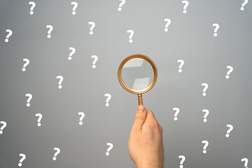 Magnifying glass with a many question mark. Looking for an answer. Search and analysis, analytics...