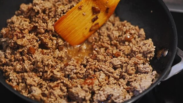 Cooking minced meat in a frying pan Delicious and savory dish Sizzling ground meat in a hot skillet, which is perfect for a variety of delicious recipes and meals