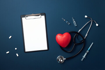 Red heart with doctor stethoscope and tablet on blue background, hospital life insurance concept,...