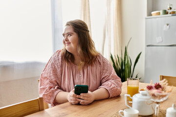 Young pretty woman with Down syndrome enjoys a cozy afternoon at home with her smartphone