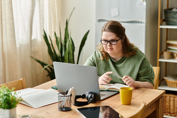 Young pretty woman with Down syndrome engaged in creative work at home in a cozy environment