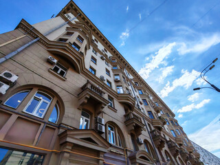 A close-up of a historic building facade with air conditioning units disrupting its elegant design....