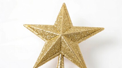 Fototapeta premium Golden glitter star tree topper, sparkling with festive shine, ideal for decorating Christmas trees and adding a touch of elegance to holiday decor. Isolated on white