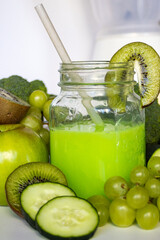 Glass jar with green smoothie, healthy fruit and vegetables