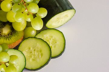 Fresh green fruits and vegetables for a healthy menu. Raw food concept. Variety of organic fruits and vegetables. Vegan menu. Space for text.